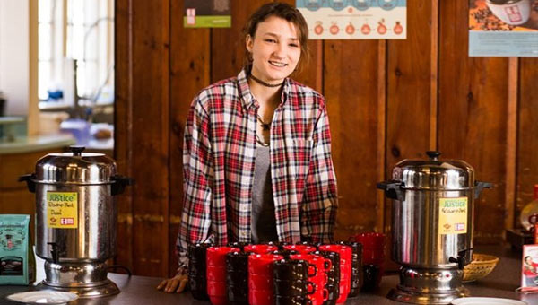 Young woman serving coffee at coffee hour
